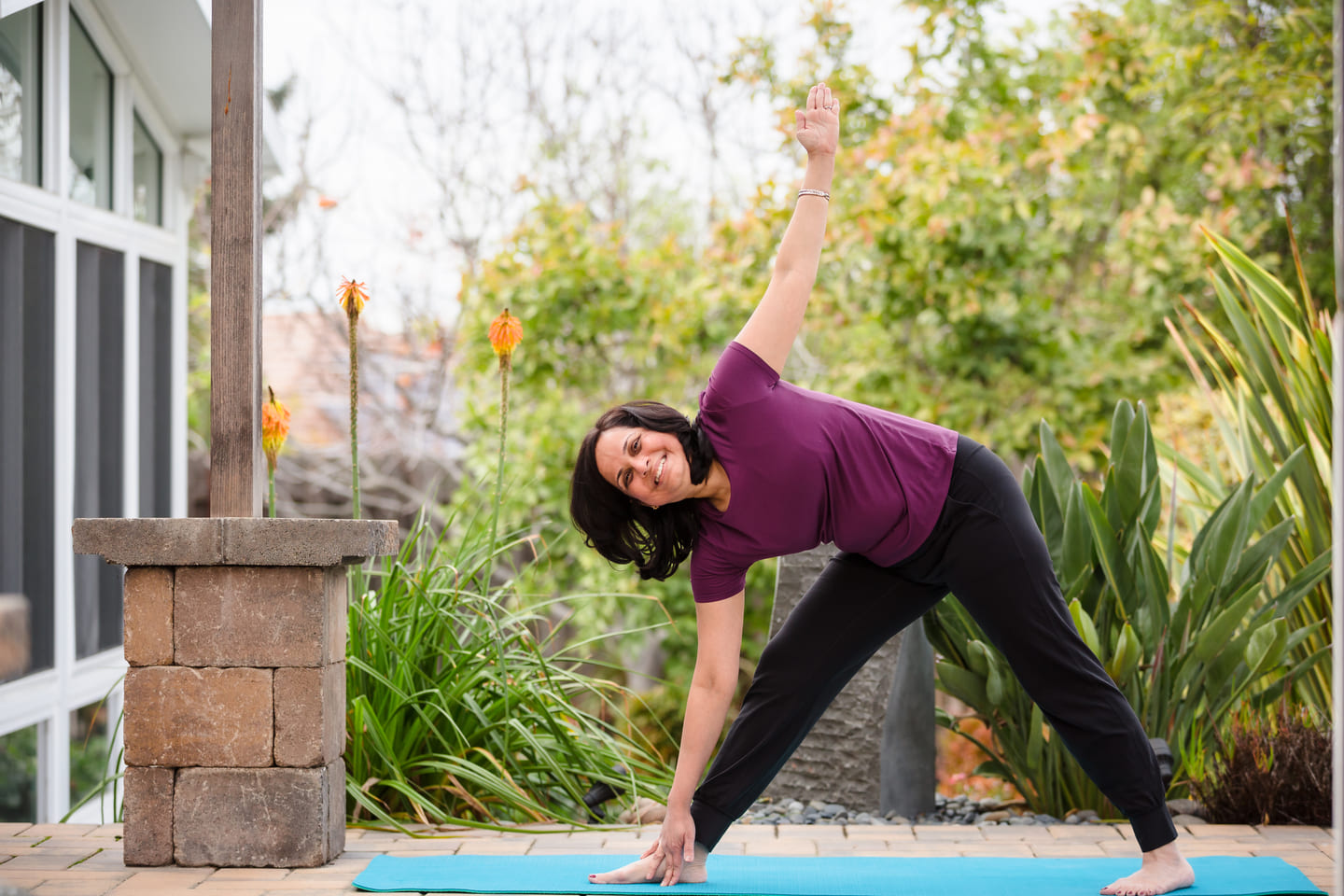 Dr. Malathi Acharya practicing yoga, reflecting Ayurvedic principles applied within a physician-led integrative medicine practice